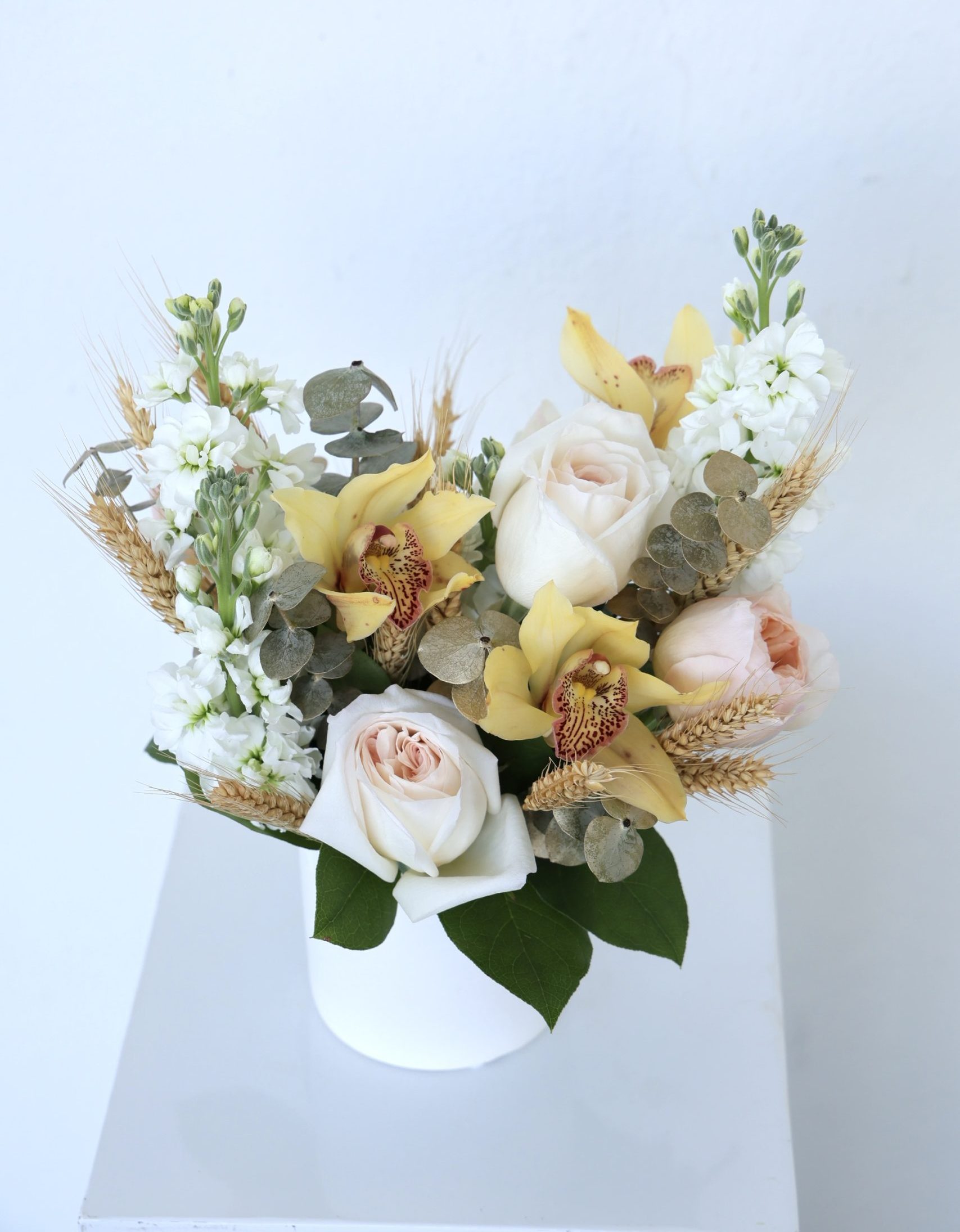 Wheat and petals shavuot centerpiece with garden roses and orchid