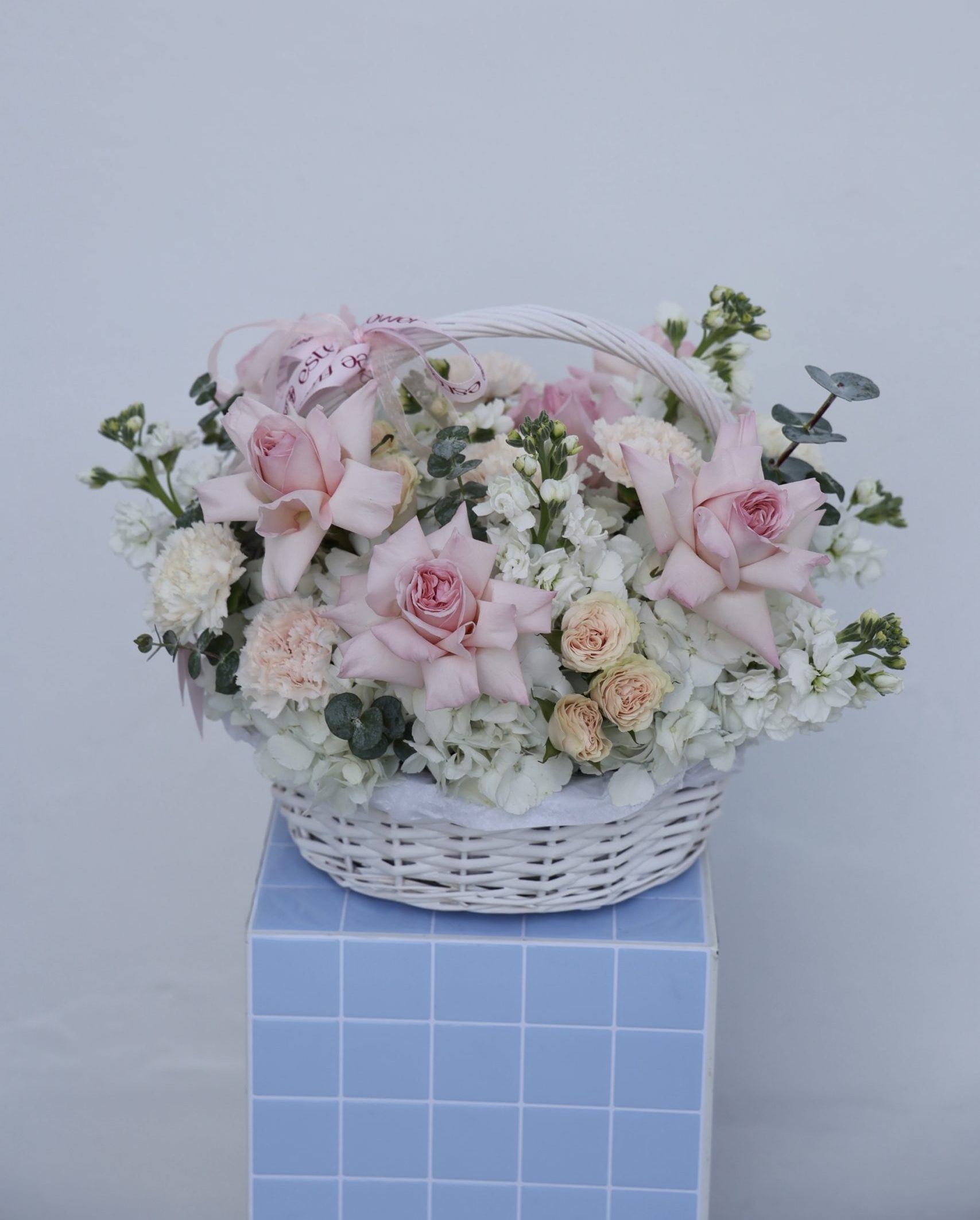 The thinking of you arrangement flower basket with garden roses and soft pastel blooms