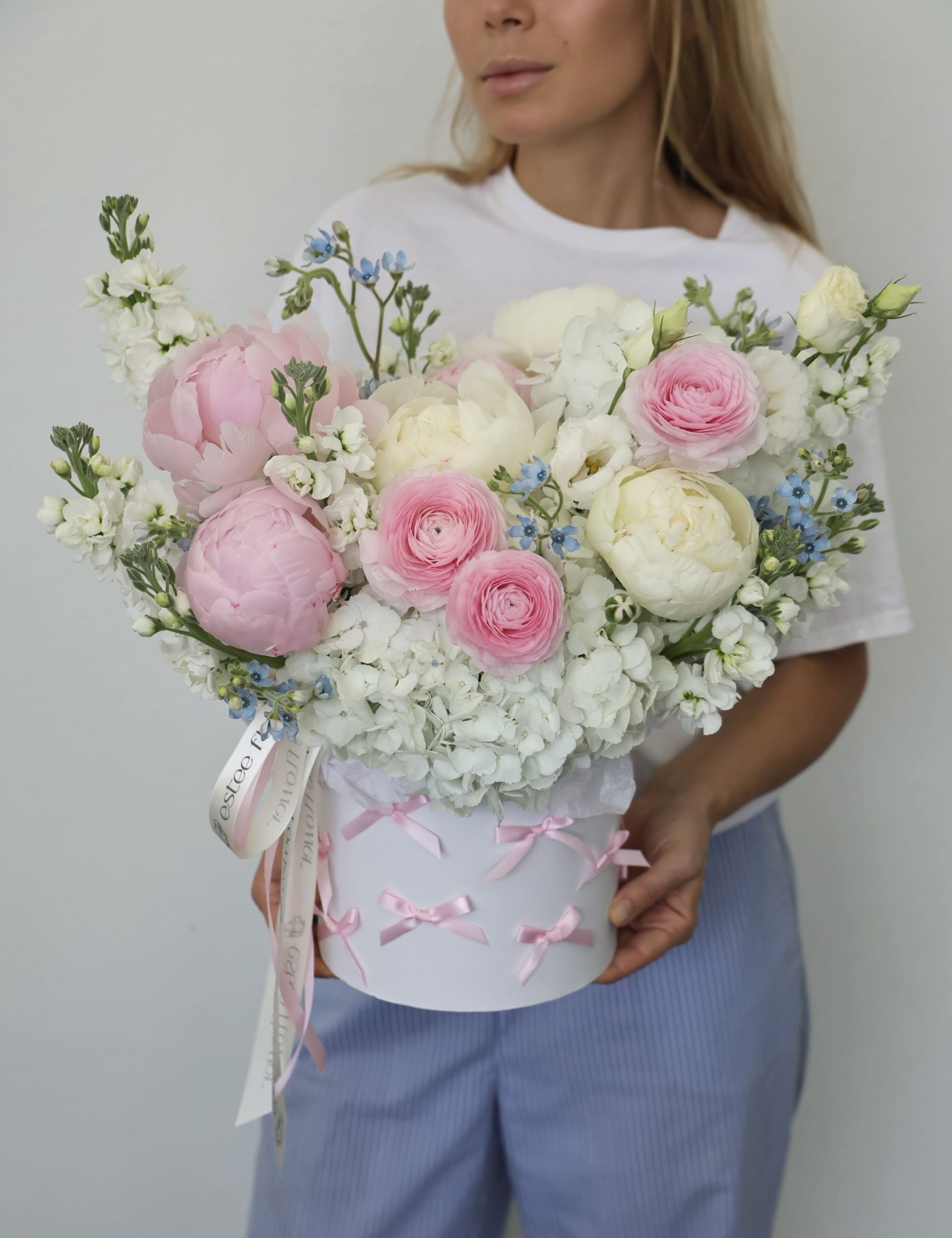 light pink hat box arrangement with peonies