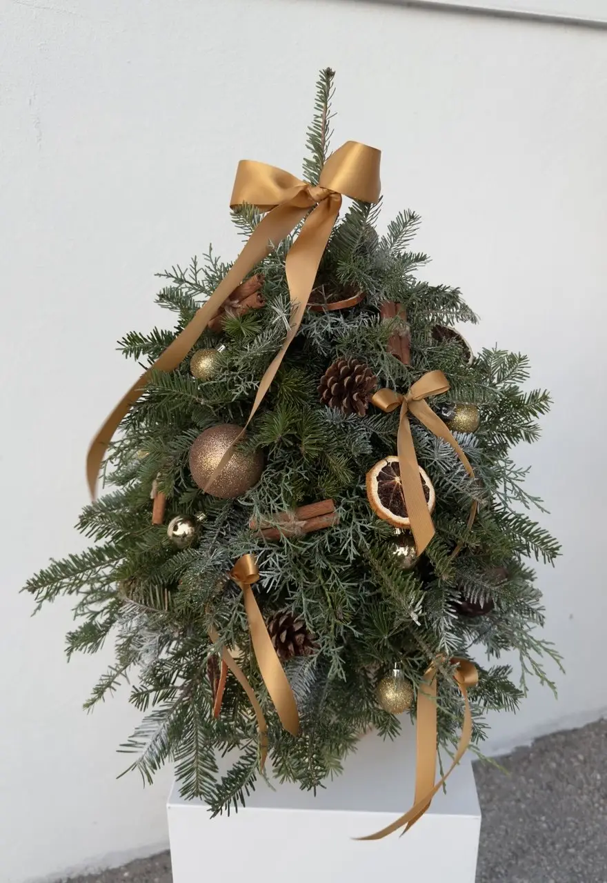 golden Christmas tree decor made from aromatic Christmas greenery